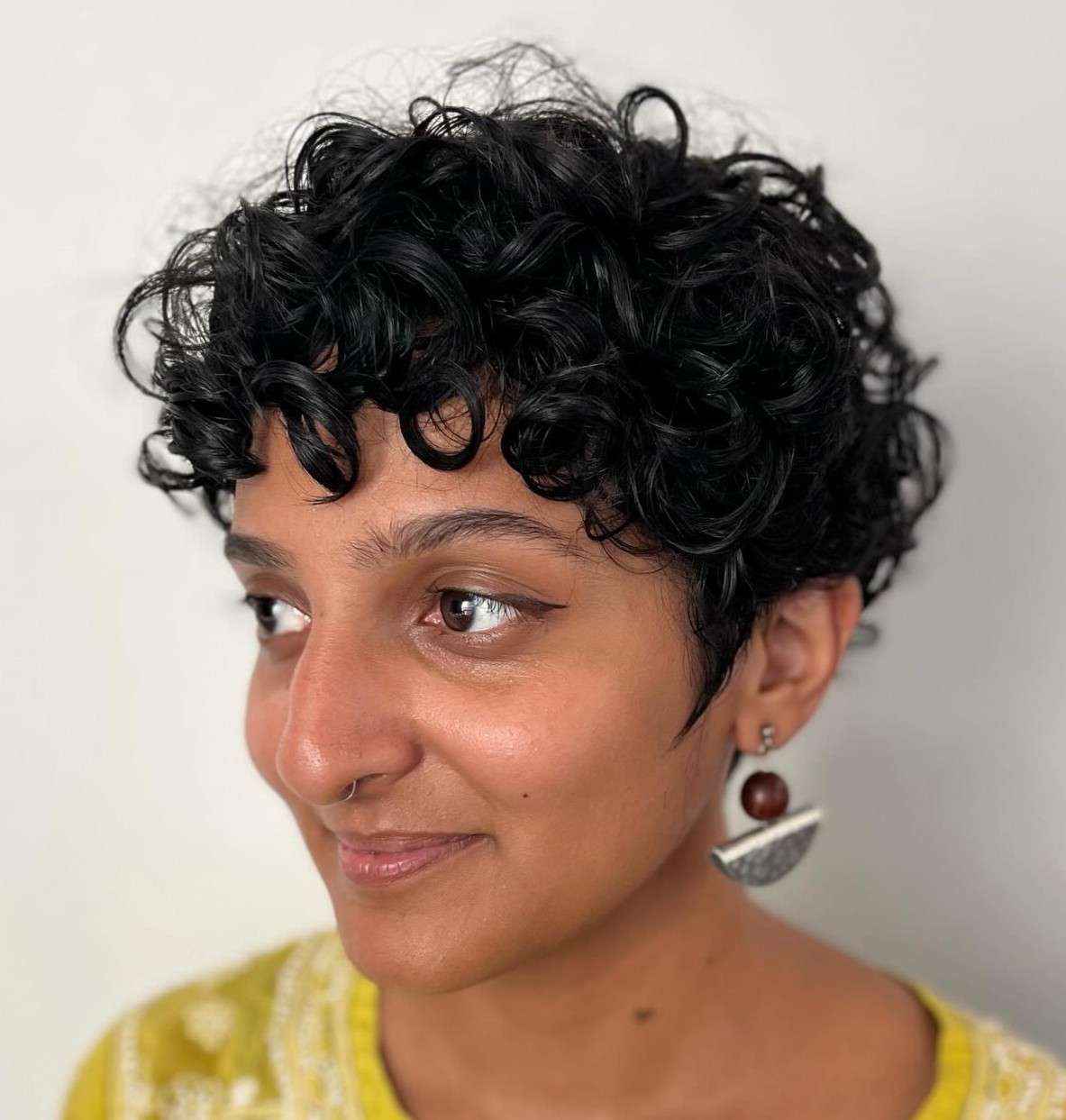 Thick Curly Pixie with Bangs