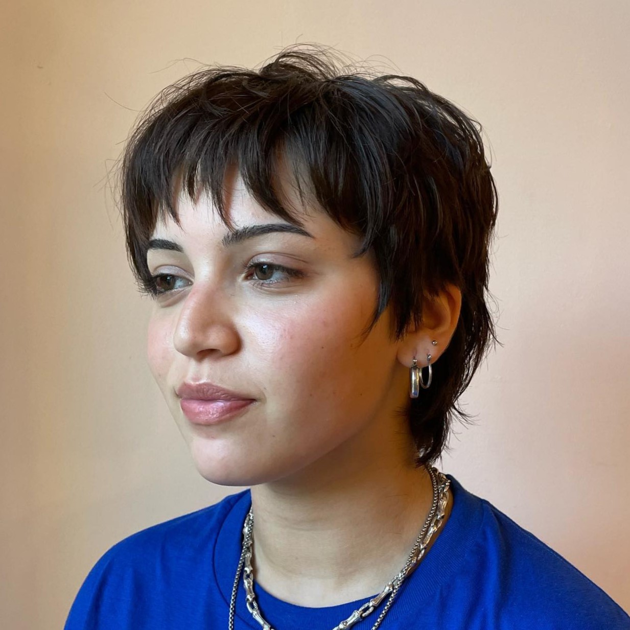 Shaggy Pixie with Razored Bangs and Longer Length at the Nape